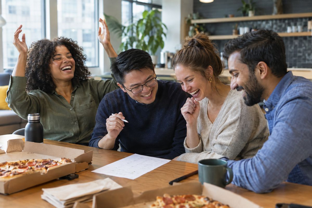 A team of coworkers celebrating at an office trivia night